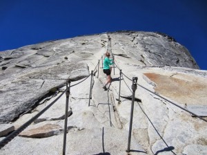 Figure 2 - SuzyR climbing the cables up Half Dome, (c) SR 2013 and  reproduced with permission.