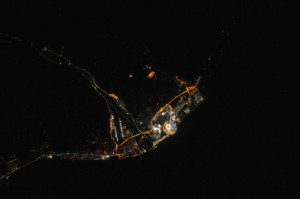 Figure 1 - The Sochi Olympic Village photographed at night from the USS.  Zoom in on the stadium and you can see the Olympic Torch.  Photograph from NASA and in the public domain.